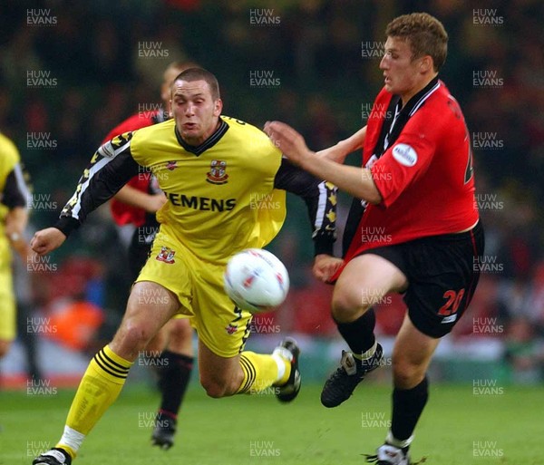 240503 - Bournemouth v Lincoln City - Third Division Play-Off Final - Lincoln's Dene Cropper is challenged by Phillip Gulliver