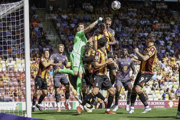 130822 - Bradford City v Newport County - Sky Bet League 2 - Harry Lewis of Bradford punches clear under pressure from Cameron Norman 