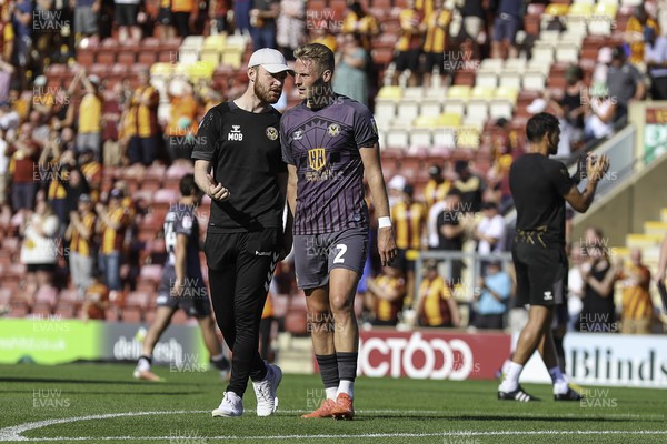 130822 - Bradford City v Newport County - Sky Bet League 2 - Cameron Norman of Newport and a coach leave the field at full time 