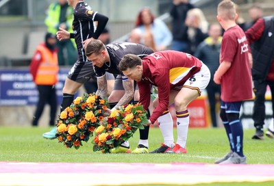 270424 - Bradford City v Newport County - Sky Bet League 2 - players from both sides lay a remembrance wreath at the 39th anniversary of the Bradford fire