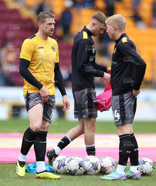 270424 - Bradford City v Newport County - Sky Bet League 2 - Scot Bennett of Newport County and Ryan Delaney of Newport County warm up before the match