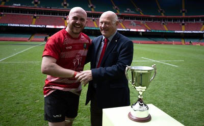 190426 - Brecon Athletic v Bargoed Athletic, Mens Division 5 Final - Captain Will Prosser of Brecon Athletic receives the trophy from WRU President Terry Cobner celebrates after winning the final