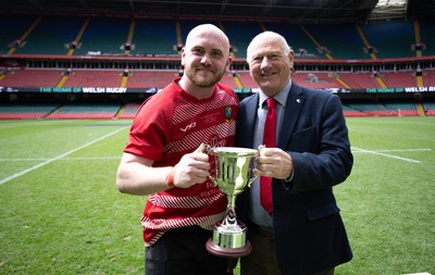 190426 - Brecon Athletic v Bargoed Athletic, Mens Division 5 Final - Captain Will Prosser of Brecon Athletic receives the trophy from WRU President Terry Cobner celebrates after winning the final