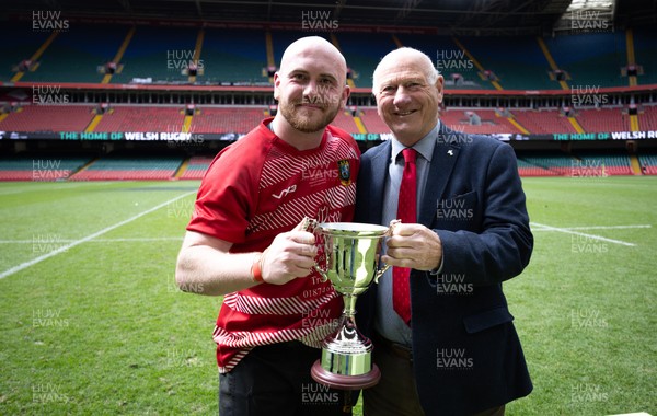190426 - Brecon Athletic v Bargoed Athletic, Mens Division 5 Final - Captain Will Prosser of Brecon Athletic receives the trophy from WRU President Terry Cobner celebrates after winning the final