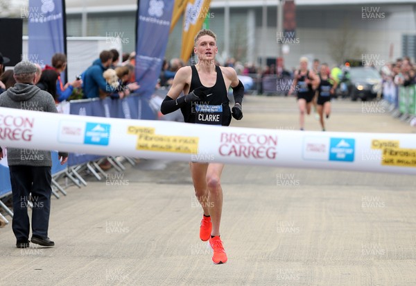 310319 - Brecon Carreg Cardiff Bay Run - Winner Adam Clarke coming over the line