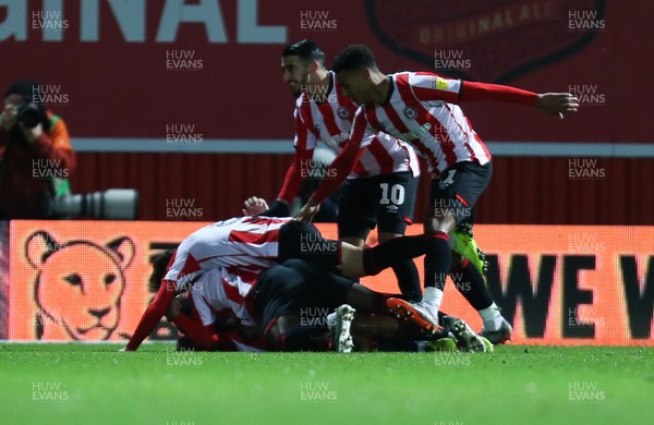 111219 - Brentford v Cardiff City, Sky Bet Championship - Team mates celebrate with Bryan Mbeumo of Brentford after scoring the first goal
