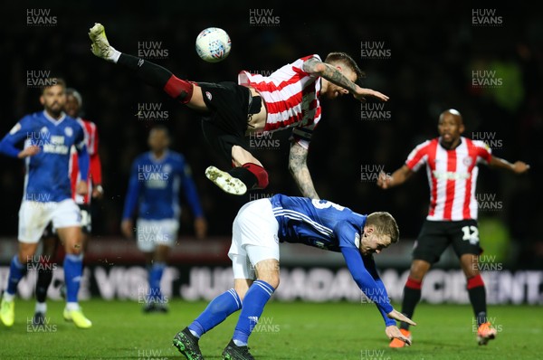 111219 - Brentford v Cardiff City, Sky Bet Championship - Danny Ward of Cardiff City collides with Pontus Jansson of Brentford as the complete for the ball