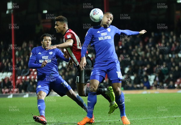 130318 - Brentford v Cardiff City, Sky Bet Championship - Kenneth Zohore of Cardiff City wins the ball from Ollie Watkins of Brentford