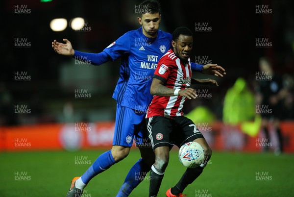 130318 - Brentford v Cardiff City, Sky Bet Championship - Marko Grujic of Cardiff City and Josh Clarke of Brentford compete for the ball