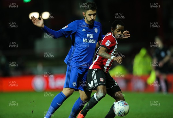 130318 - Brentford v Cardiff City, Sky Bet Championship - Marko Grujic of Cardiff City and Josh Clarke of Brentford compete for the ball
