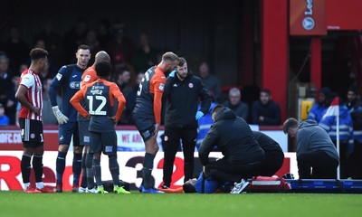 081218 - Brentford v Swansea City - SkyBet Championship - Martin Olsson of Swansea City is treated before being stretchered from the field