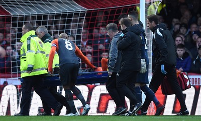 081218 - Brentford v Swansea City - SkyBet Championship - Martin Olsson of Swansea City is treated before being stretchered from the field