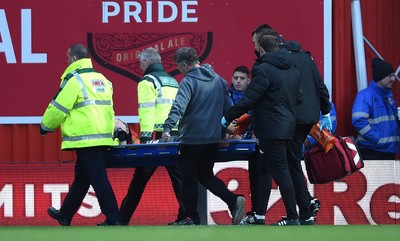 081218 - Brentford v Swansea City - SkyBet Championship - Martin Olsson of Swansea City is treated before being stretchered from the field