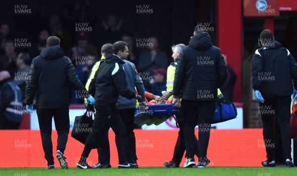 081218 - Brentford v Swansea City - SkyBet Championship - Martin Olsson of Swansea City is treated before being stretchered from the field