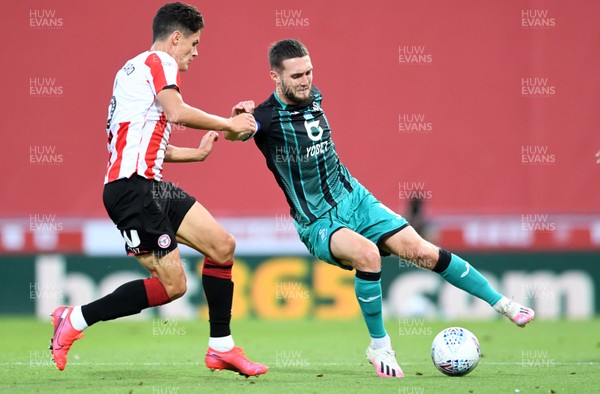 290720 - Brentford v Swansea City - EFL SkyBet Championship Play-Off - Matt Grimes of Swansea City is tackled by Christian Norgaard of Brentford