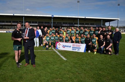 260425 - Bridgend Athletic v Skewen - Admiral National League 1 West Central - Kerry Frey of the WRU presents Bridgend Athletic Captain Jonathan Phillips with the trophy