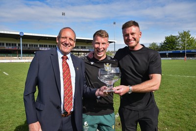260425 - Bridgend Athletic v Skewen - Admiral National League 1 West Central - Kerry Frey of the WRU presents Bridgend Athletic Captain Jonathan Phillips and sponsor, Harry Griffiths with the trophy