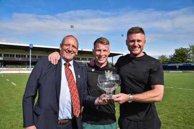 260425 - Bridgend Athletic v Skewen - Admiral National League 1 West Central - Kerry Frey of the WRU presents Bridgend Athletic Captain Jonathan Phillips and sponsor, Harry Griffiths with the trophy