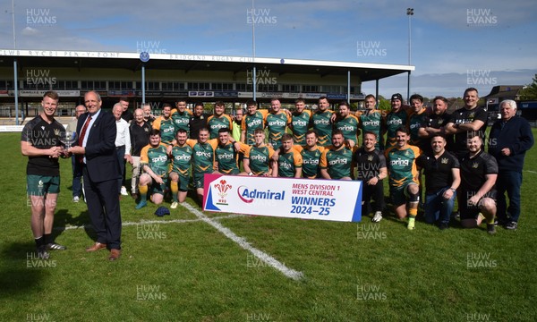 260425 - Bridgend Athletic v Skewen - Admiral National League 1 West Central - Kerry Frey of the WRU presents Bridgend Athletic Captain Jonathan Phillips with the trophy