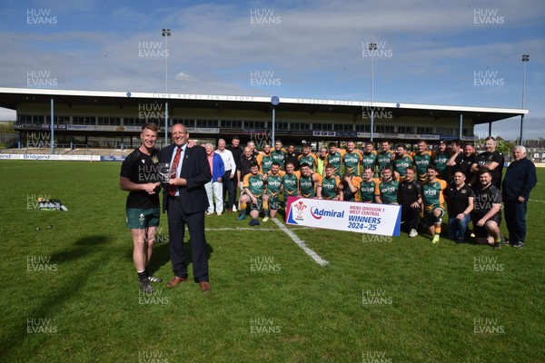 260425 - Bridgend Athletic v Skewen - Admiral National League 1 West Central - Kerry Frey of the WRU presents Bridgend Athletic Captain Jonathan Phillips with the trophy