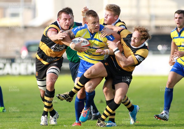 041014 Bridgend Ravens RFC v Newport RFC - Principality Premiership -Adam Williams of Bridgend is tackled by Rhys Jenkins(L) Barney Nightingale and Andrew Quick of Newport