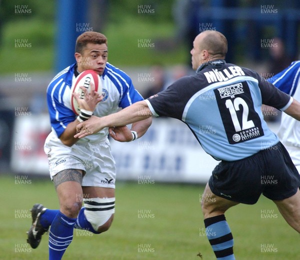 160503 - Bridgend v Cardiff - Welsh Premiership - Bridgend's Josh Taumalolo is tackled by Pieter Muller