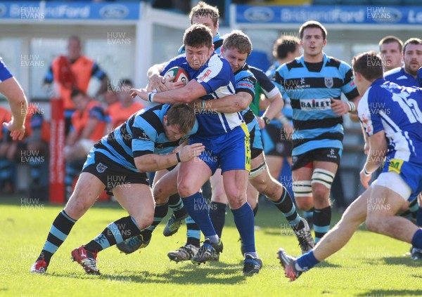 201012 Bridgend RFC Cardiff RFC - British and Irish Cup -Bridgend's Ashley James is tackled by Cardiff's Rhys Williams(L) and Tom Young