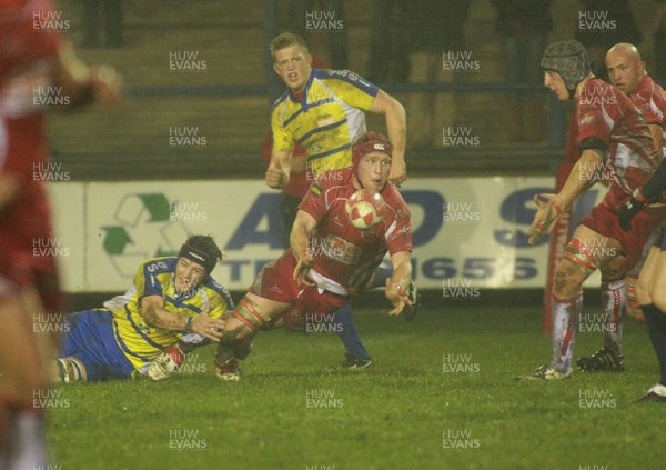 090312 Bridgend RFC v Llandovery RFC - Principality Premiership -Llandovery's Shaun Jones offloads as Bridgend's Andrew Waite makes the tackle