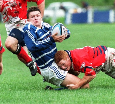 230897 - Bridgend v Llanelli - Adrian Durston of Bridgend is tackled by Darryl Williams