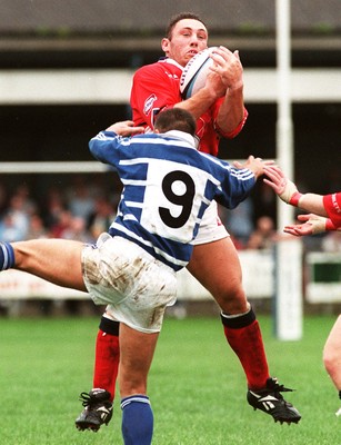 230897 - Bridgend v Llanelli - Robin Mcbryde is tackled by Karl Hammans