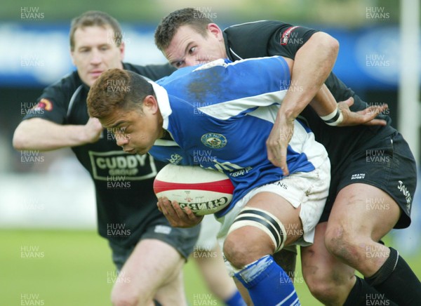 200503 - Bridgend v Neath - Welsh Premiership - Bridgend's Josh Taumalolo is tackled by John Leyshon