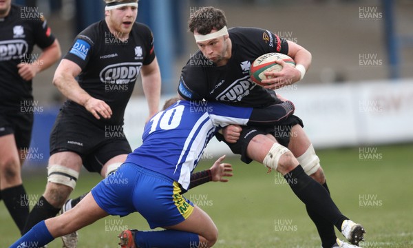 230213 - Bridgend v Neath, Principality Premiership - Neath's Jonny Griffiths is tackled by Bridgend's Lewis Williams