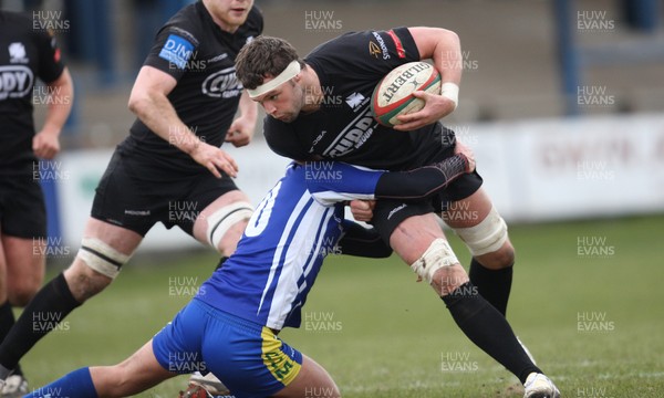 230213 - Bridgend v Neath, Principality Premiership - Neath's Jonny Griffiths is tackled by Bridgend's Lewis Williams