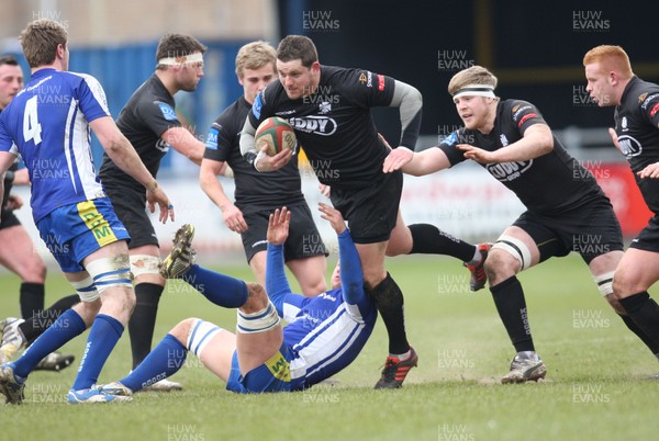 230213 - Bridgend v Neath, Principality Premiership - Neath's Bowdy Davies is held by the Bridgend defence