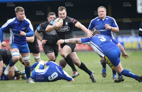 230213 - Bridgend v Neath, Principality Premiership - Neath's Lloyd Phillips is challenged by Bridgend's Owen Williams