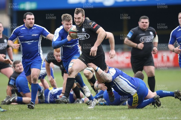 230213 - Bridgend v Neath, Principality Premiership - Neath's Lloyd Phillips is challenged by Bridgend's Owen Williams