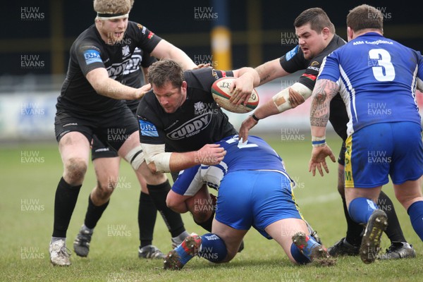 230213 - Bridgend v Neath, Principality Premiership - Neath's Gareth Gravell is tackled by Bridgend's Gary Carpenter