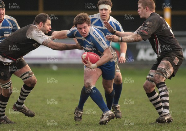 14.01.12 Bridgend RFC v Pontypridd RFC - Principality Premiership - Bridgend's Arthur Ellis fends off Pontypridd's Chris Dicomodis(L) 