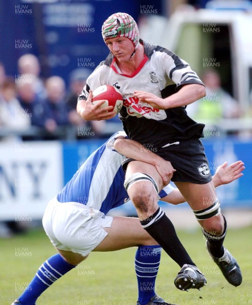 240503 - Bridgend v Pontypridd - Welsh Premiership - Pontypridd's Brent Cockbain gets past tackle from Huw Harries