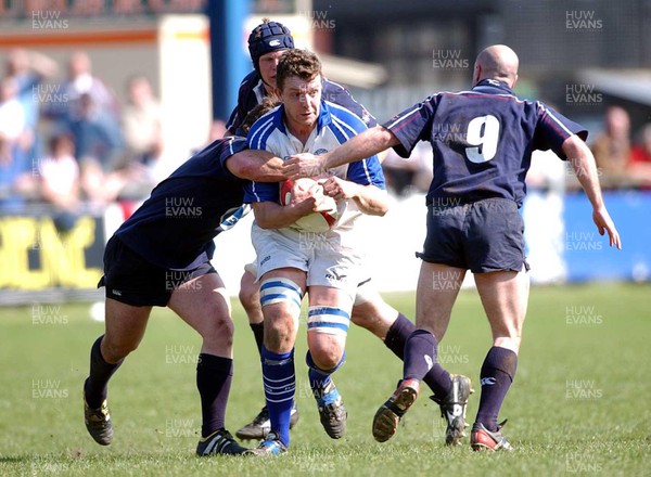 050403 - Bridgend v Swansea - Principality Cup Quarter Final - Bridgend's Deiniol Jones is caught by James Bater (left) and Sam Cordingley (rt)