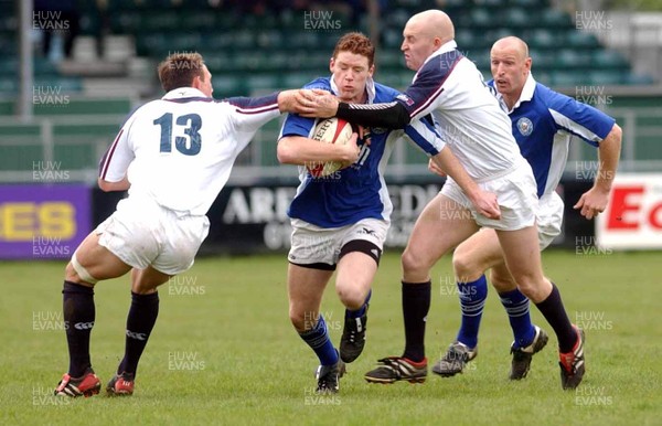 260403 - Bridgend v Swansea - Welsh Premiership - Bridgend's David Bishop gets stopped by Mark Taylor (L) and Steve Winn