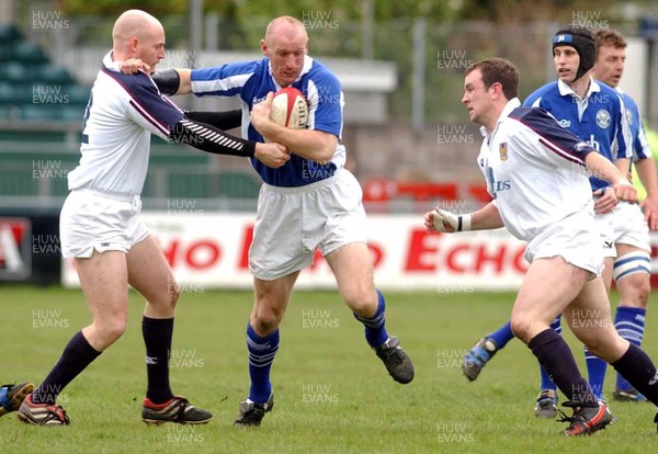 260403 - Bridgend v Swansea - Welsh Premiership - Bridgend's Gareth Thomas hands off Steve Winn