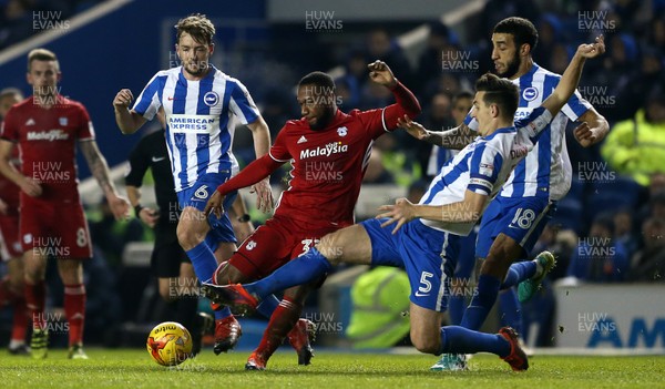 240117 - Brighton & Hove Albion v Cardiff City - SkyBet Championship - Junior Hoilett of Cardiff City is tackled by Lewis Dunk of Brighton