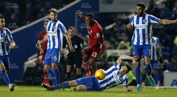 240117 - Brighton & Hove Albion v Cardiff City - SkyBet Championship - Junior Hoilett of Cardiff City is tackled by Lewis Dunk of Brighton