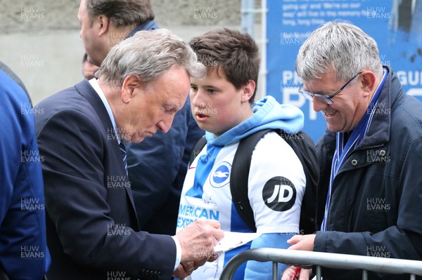 160419 - Brighton and Hove Albion v Cardiff City - Premier League - Manager Neil Warnock happily signs autographs when the team arrive