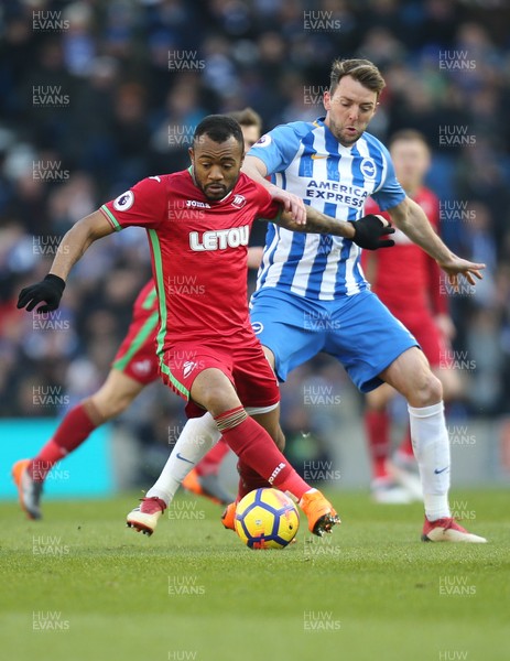 240218 - Brighton and Hove Albion v Swansea City, Premier League - Jordan Ayew of Swansea City takes on Dale Stephens of Brighton