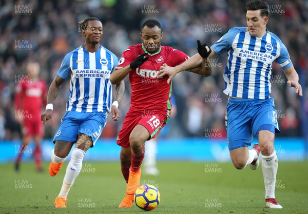 240218 - Brighton and Hove Albion v Swansea City, Premier League - Jordan Ayew of Swansea City is is tackled by Lewis Dunk of Brighton