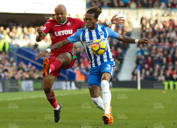 240218 - Brighton and Hove Albion v Swansea City, Premier League - Andre Ayew of Swansea City and Gaetan Bong of Brighton compete for the ball