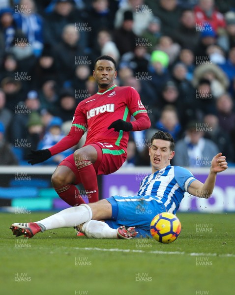 240218 - Brighton and Hove Albion v Swansea City, Premier League - Luciano Narsingh of Swansea City is challenged by Lewis Dunk of Brighton as he crosses the ball