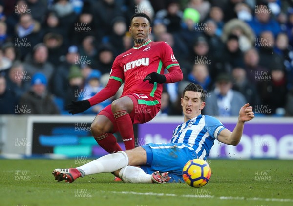 240218 - Brighton and Hove Albion v Swansea City, Premier League - Luciano Narsingh of Swansea City is challenged by Lewis Dunk of Brighton as he crosses the ball